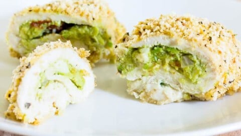 sliced Guacamole Stuffed Chicken Breasts on a white plate