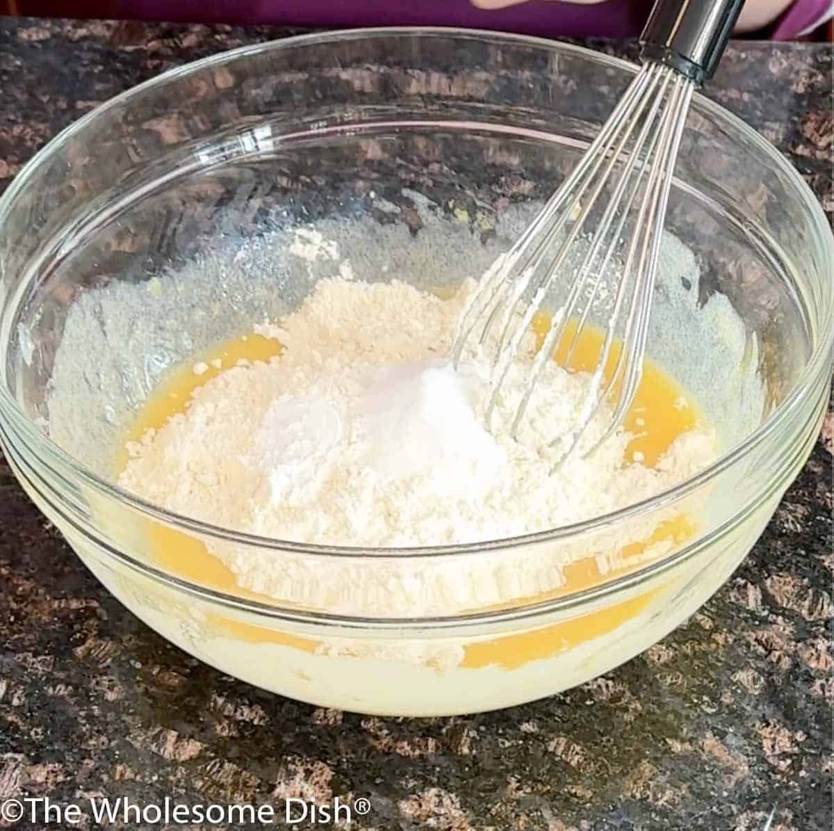 Adding the dry ingredients to the mixing bowl.