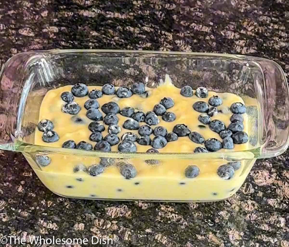 Raw blueberry lemon bread batter in a loaf pan.