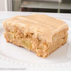 Apple blondie with maple cream cheese frosting on a plate.