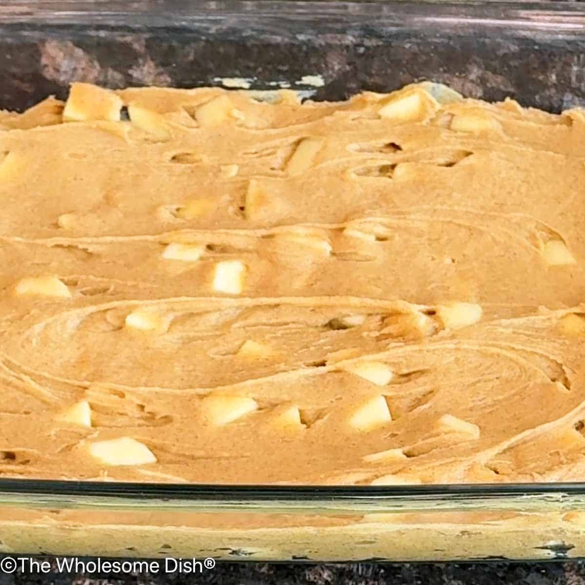 Blondie batter spread out evenly in a baking dish.