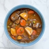 Beef stew in a blue bowl.