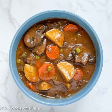 Beef stew in a blue bowl.