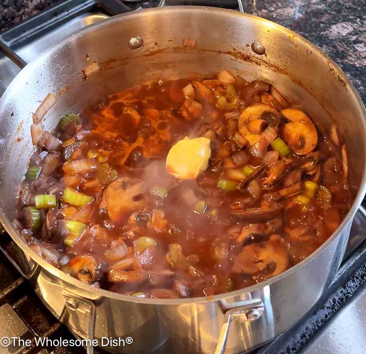 Red wine, Worcestershire sauce, and dijon mustard added to the pot.